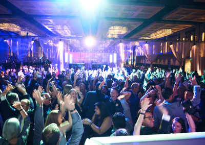 A Crowd of People Dancing at a OneSource Strategy Event Party