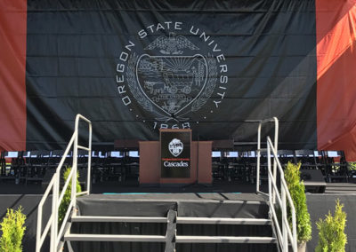 A stage with stairs leading up the center at a OneSource Strategy higher education ceremony event