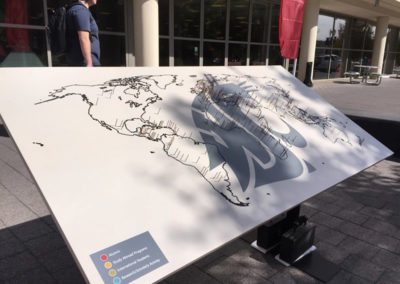 A world map display showing locations of alumni, study abroad programs, international students, and research/scholarly activity around the world at a OneSource Strategy higher education event