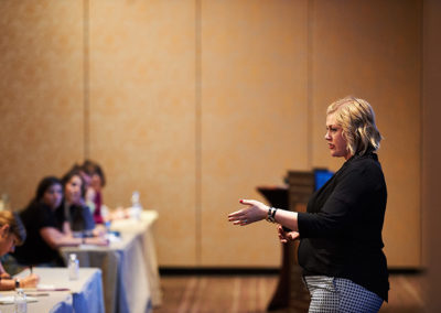 A Woman Presents During a Training Breakout Session at a OneSource Strategy Event