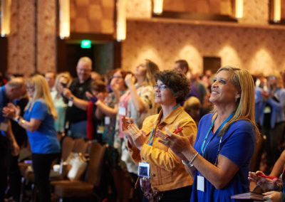 A Crowd Clapping After a Presentation at a OneSource Strategy Event