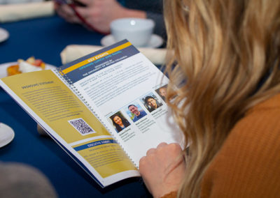 A person reviewing training material at a OneSource Strategy assocation event